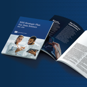 Cover page of the NIH Strategic Plan for Data Science that shows a man and a woman looking at notes on a tablet and a spreadsheet. Behind the cover are open pages showing some of the content inside the strategic plan.